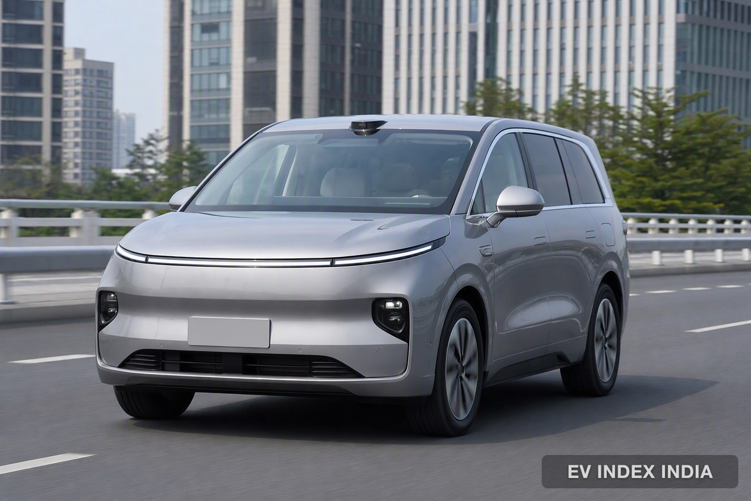 A silver tall electric crossover on a modern city road