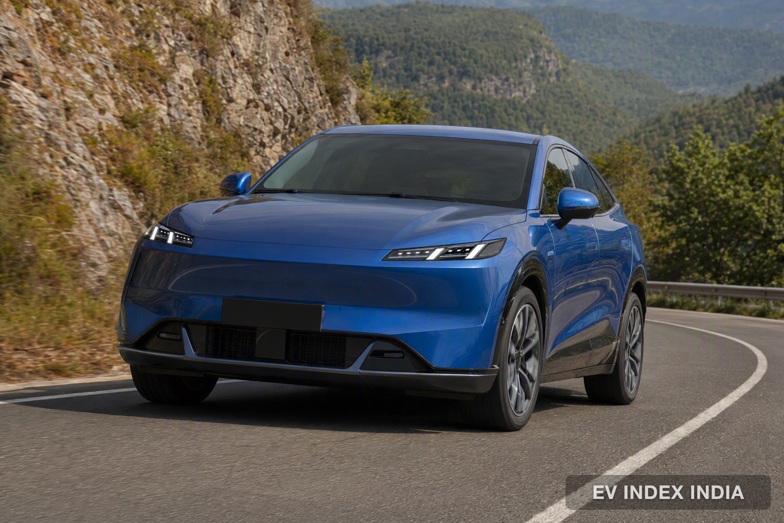 A blue coupe-style electric SUV on a coastal road