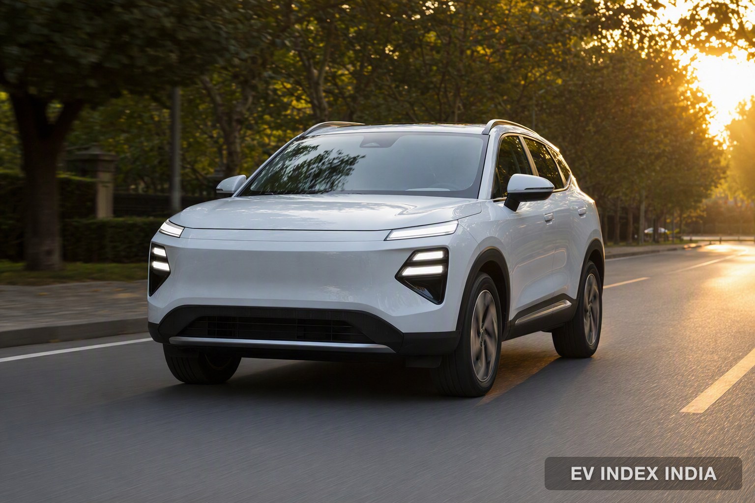 A white compact electric SUV on a leafy city road at sunrise