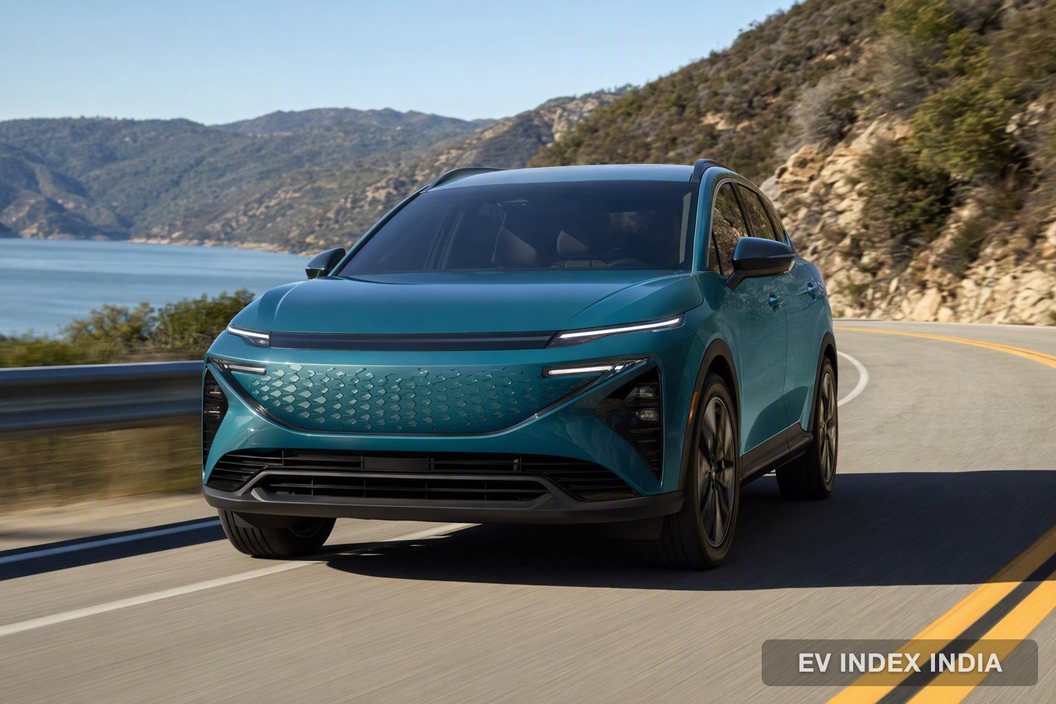 A teal electric SUV on a scenic highway